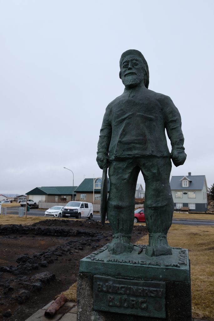 Statue of the fisherman in Eyrarbakki, with the van in the background
